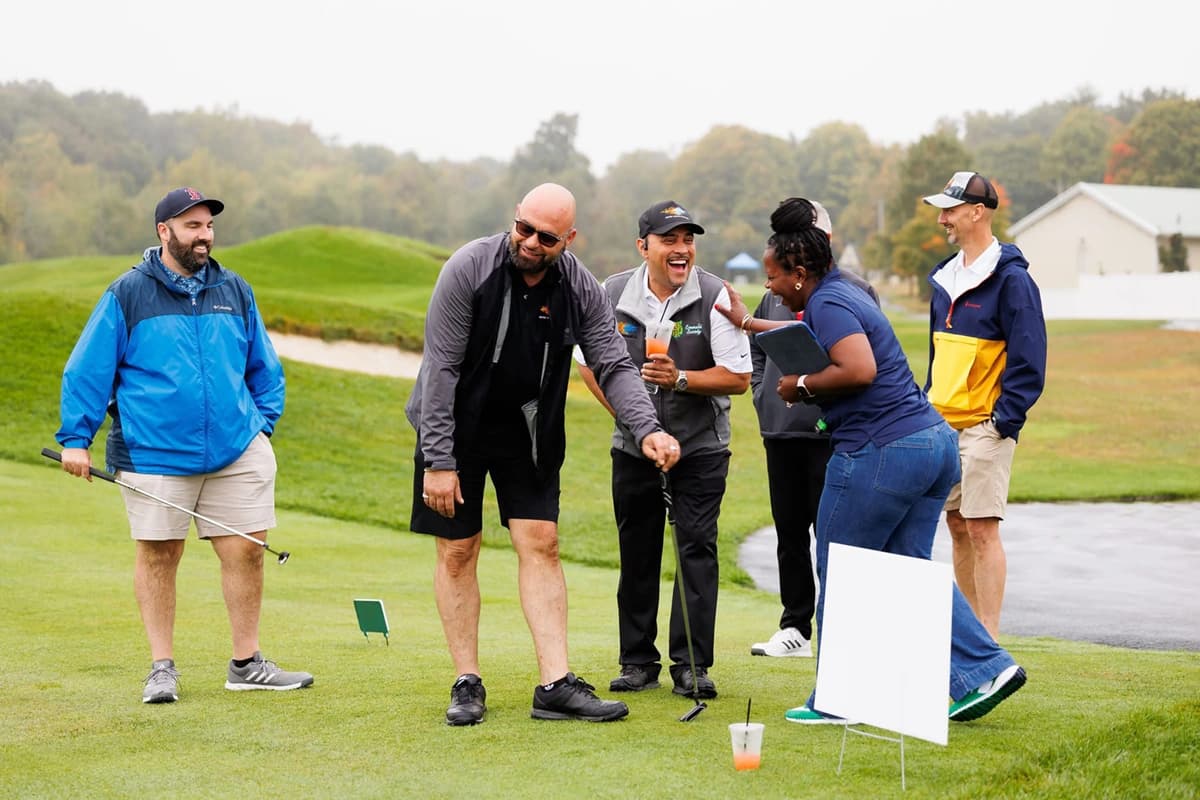 People laughing on a golf course