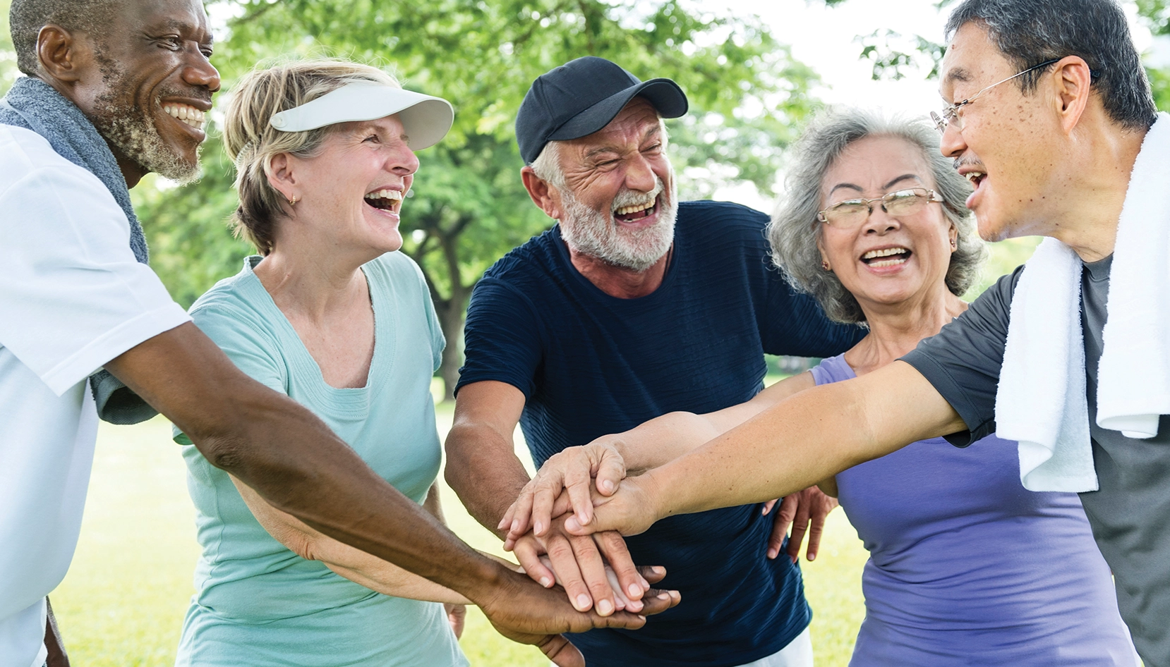 A group of people holding hands in a park